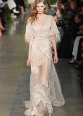 Long transparent dress on the floor with a printed lace of milky color