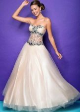 The dress is white and green with a transparent corset and rhinestones.