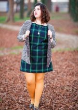 Green dress in a cage for obese women in combination with yellow tights