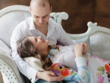 Photo session of a pregnant woman with her husband in a photo studio